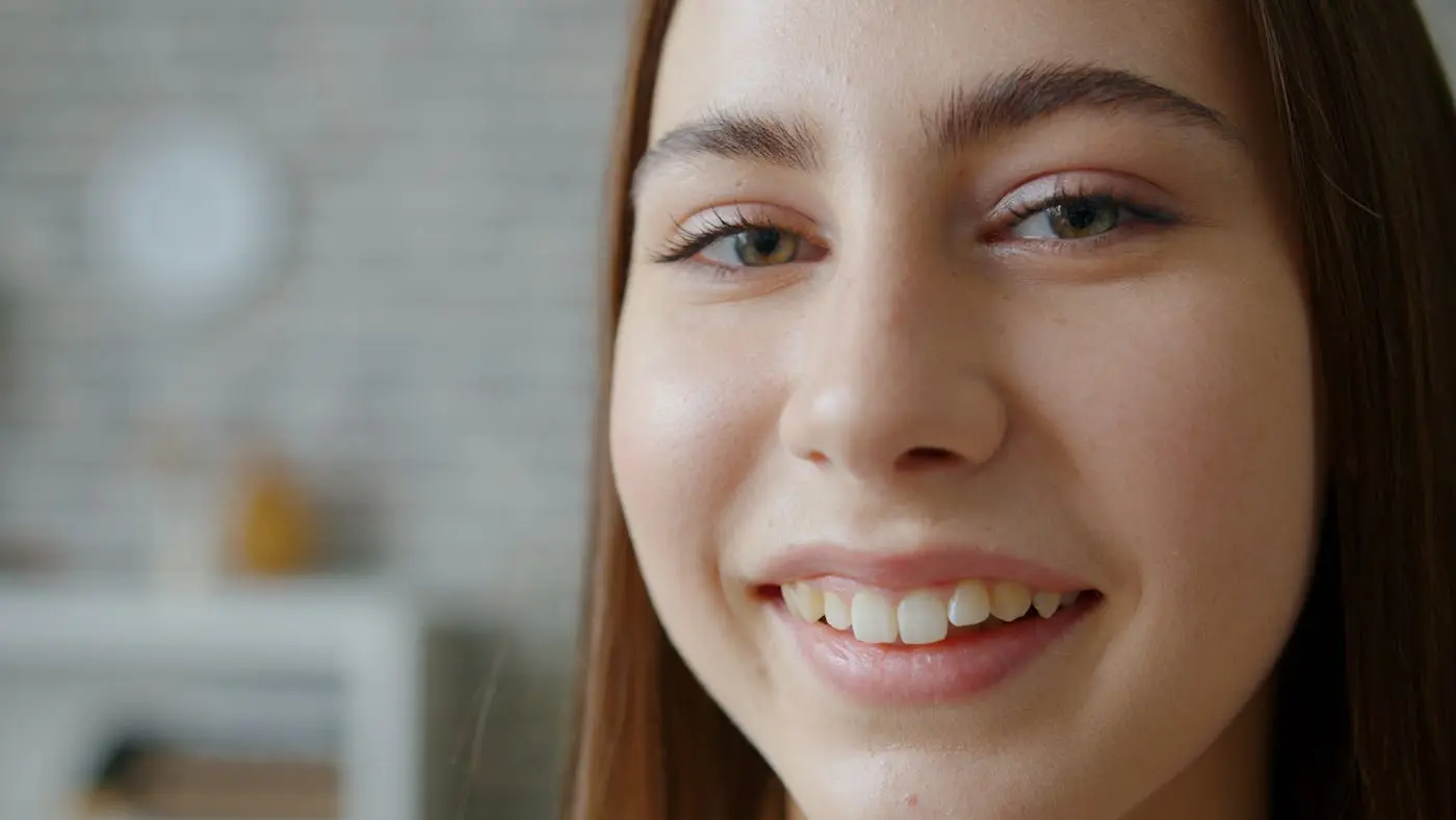 Young woman smiling confidently with clear aligners